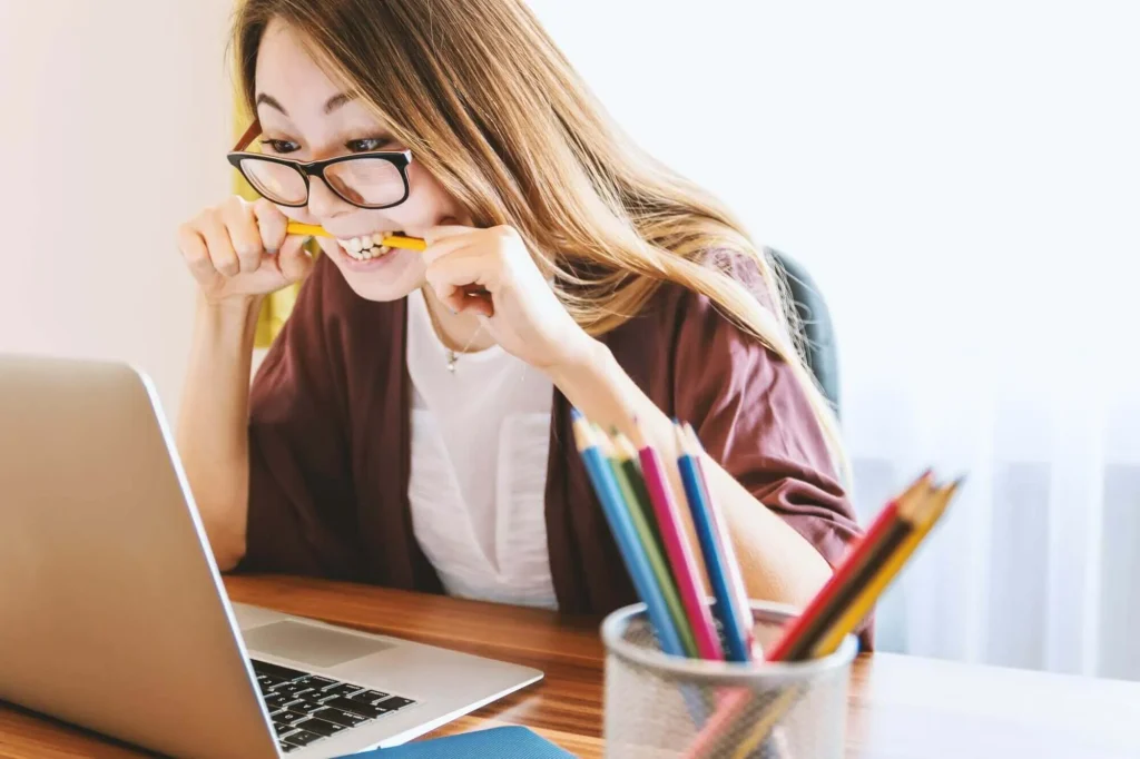 Nervous young woman in front of her computer